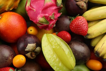 Assortment of fresh exotic fruits as background, top view