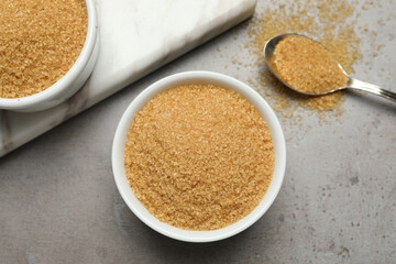 Brown sugar on grey table, flat lay