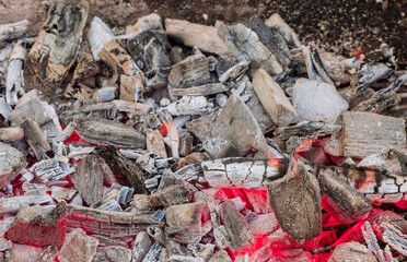 The preparation of fire for a BBQ to by burning charcoal logs the grill with cooking