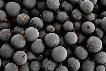 Tasty frozen black currants as background, top view