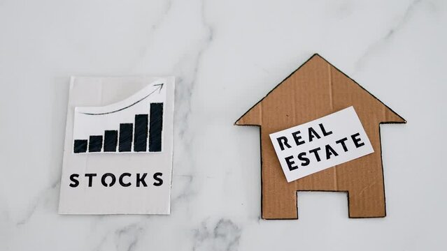 investment opportunities and building wealth, house icon next to stock market stats symbol of alternative financial choices