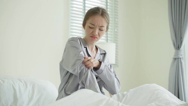 Young Caucasian woman scratching hands after wake up in the morning.