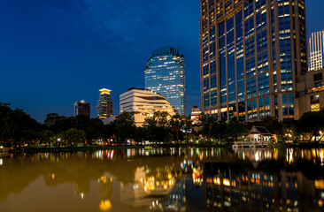 Naklejka premium Reflections in a lake at Queen's Park (Benchasiri Park) in downtown Bangkok