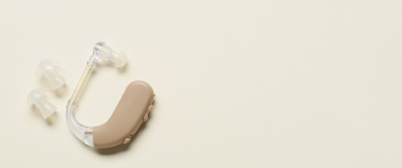 Hearing aid on light background with space for text