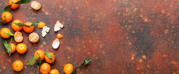 Fototapeta na wymiar Sweet tangerines on grunge background with space for text