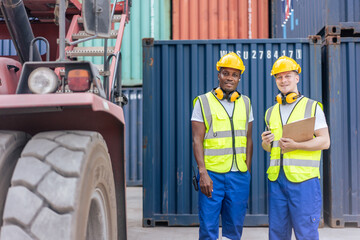 Portrait of Caucasian worker and African man work in container port. 