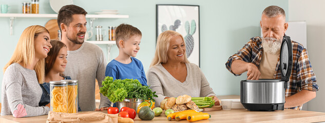 Happy family using modern multi cooker in kitchen