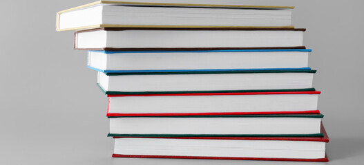 Stack of books on grey background
