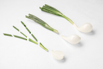 Composition with fresh green onion on light background
