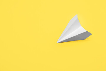 Paper plane on yellow background