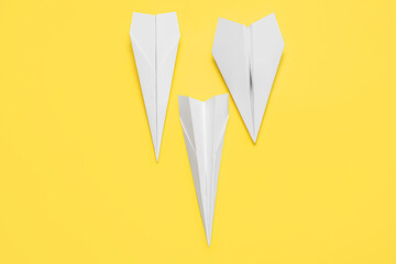 Paper planes on yellow background