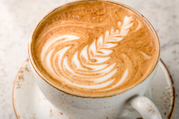 coffee cappuccino with beautiful pattern on marble table macro close up