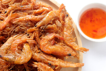 Shrimp fritters, deep fried small shrimp served with sweet sauce on white background. Battered and deep fried small shrimp, Thai style food.