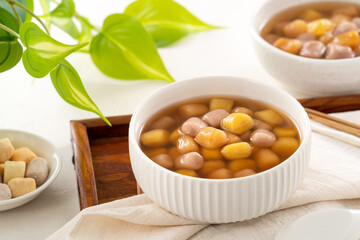 Delicious sweet taro ball soup in a white bowl for serving.