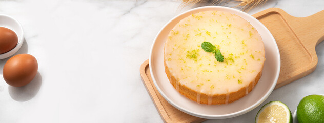 Delicious Lemon Glazed Pound Sponge cake on white marble table background.