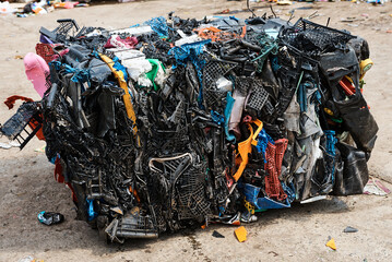 Pack of plastic materials in recycling plant yard closeup
