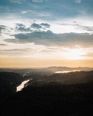 Aerial view on the orange sky, sunset sun and clouds near the rural tropical area in Malaysia.
