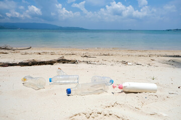 Plastic waste, water bottles and plastic bottles and a lot of dirt on the beach She put it in a garbage bag. concept of environmental protection and global warming reduction