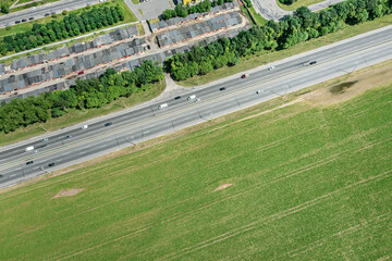 asphalt highway through green summer fields. aerial view in summer sunny day.