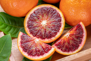 Blood orange fruit in wooden basket on wooden background, Red Blood orange with slice in wooden...