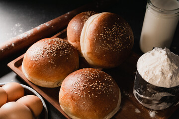 hamburger bun in home kitchen, dark photography, moody