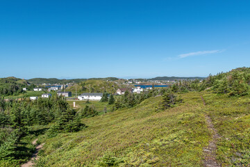 Fototapeta na wymiar A look back at the small town of Twillingate, Newfoundland, as seen from the hiking trail to Spiller's Cove on a beautiful sunny day.