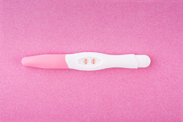 Positive pregnancy test isolated on pink background