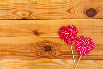 Colorful lollipops on wooden background. Top view