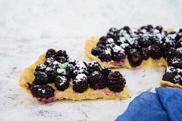 Delicious tart with blackberries on white background