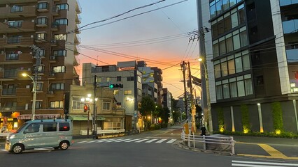 The sunset at the crossings of old downtown Tokyo, beautiful orange gradation, Nezu year 2022 July 30th