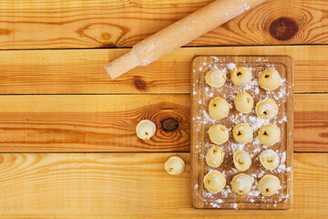 Meat dumplings, ravioli, on wooden background