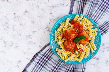 Meatballs with fusilli on white background