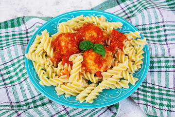 Meatballs with fusilli on white background