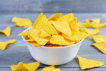 Mexican nachos with cheese. Corn chips isolated on wooden background