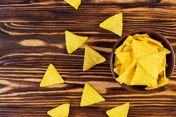 Mexican nachos with cheese. Corn chips isolated on wooden background