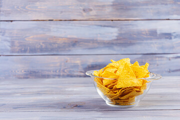 Mexican nachos with cheese. Corn chips isolated on wooden background