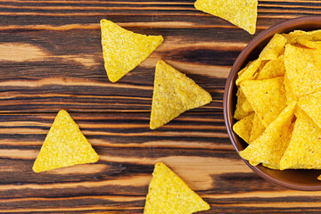 Mexican nachos with cheese. Corn chips isolated on wooden background