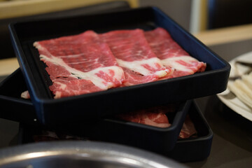 Fresh beef raw sliced with marbled texture served for Sukiyaki.