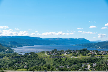 Fototapeta na wymiar The city of Corner Brook, Newfoundland is seen on a beautiful sunny late afternoon from a lookout by the highway on the way into town.