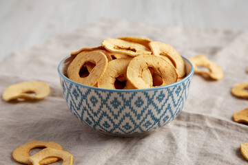 Homemade apple chips in a bowl, side view. Close-up.