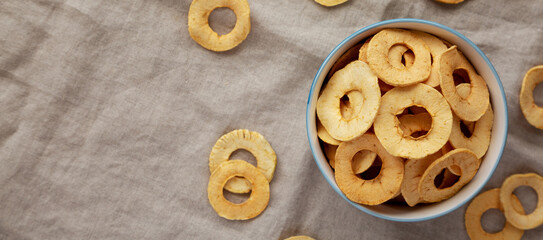 Homemade apple chips in a bowl, top view. Flat lay, overhead, from above.