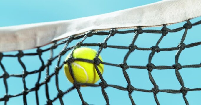 Super slow motion of hitting tennis ball into a net. Low depth of focus. Low angle of view, sky on background. Filmed on high speed cinema camera, 1000fps.