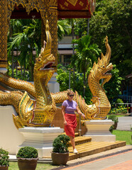 Fototapeta premium Traveler woman visiting a buddhist temple in Bangkok