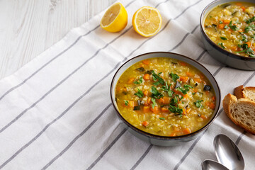 Homemade fresh lemon rice soup in a bowl, side view. Copy space.