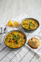 Homemade fresh lemon rice soup in a bowl, low angle view. Copy space.
