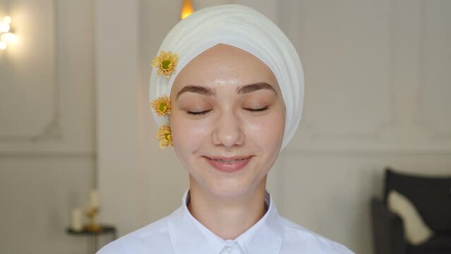 Portrait of young smiling muslim confident woman or teenage girl in dental braces on white teeth wearing traditional headscarf looking at camera. Orthodontic Treatment. self-ligating brackets. Full hd