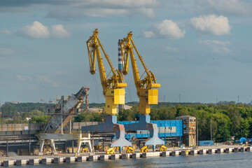 Fototapeta na wymiar Port cranes on the warf at harbour in Gdansk in POland.