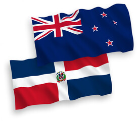 National vector fabric wave flags of New Zealand and Dominican Republic isolated on white background. 1 to 2 proportion.