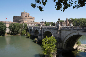 Obraz premium Ponte Sant'Angelo bridge with five arches statues of the angels and faced with travertine marbles in Rome, Italy. Cylindrical building of Castel Sant'Angelo or Mausoleum of Hadrian in background