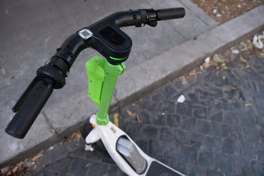 ROME, ITALY - JULY 16 2022: Close-up of the handlebar with QR code (needed to unlock the vehicle and start the ride) of a parked e-step or e-scooter for rent in a street in Rome. E-mobility